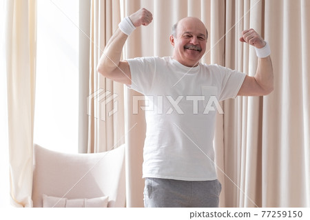 Senior man showing muscle being proud with his health 77259150