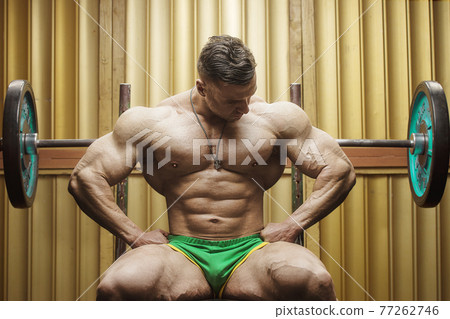 old fashion bodybuilder exercises in gym 77262746