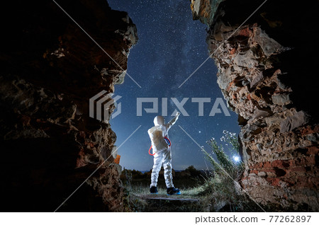 Man in special white space suit exploring stars. 77262897