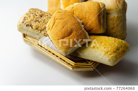 Various types of bread served on a wicker tray, delicious and fresh rolls Various types of bread served on a wicker tray, delicious and fresh rolls 77264068