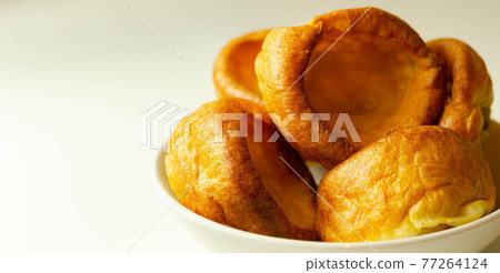 Traditional English Yorkshire pudding, wonderfully crisp and golden baked for a traditional recipe, accompaniment for the perfect Sunday roast Traditional English Yorkshire pudding, wonderfully crisp and golden baked for a traditional recipe, accompaniment for the perfect Sunday roast 77264124