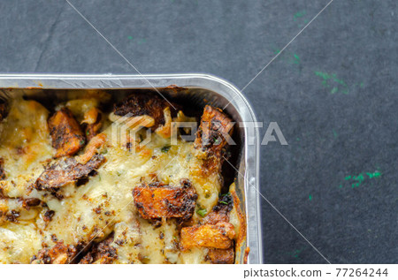 Fried potato fries coated topped with mature cheddar and Monterey Jack cheeses, jalapeno and bacon sauce, finished with mozzarella and parsley Fried potato fries coated topped with mature cheddar and Monterey Jack cheeses, jalapeno and bacon sauce, finished with mozzarella and parsley 77264244