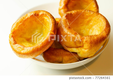 Traditional English Yorkshire pudding, wonderfully crisp and golden baked for a traditional recipe, accompaniment for the perfect Sunday roast Traditional English Yorkshire pudding, wonderfully crisp and golden baked for a traditional recipe, accompaniment for the perfect Sunday roast 77264381