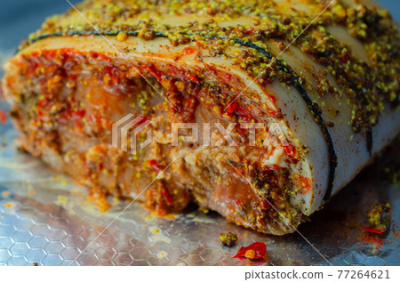 Boneless British rind-on pork loin joint, prepared in marinades, crackling joint 77264621