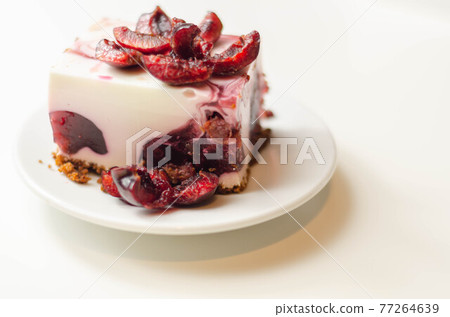 Japanese cheesecake with cherry sauce and fresh cherries on the ceramic plate and red background Japanese cheesecake with cherry sauce and fresh cherries on the ceramic plate and red background 77264639
