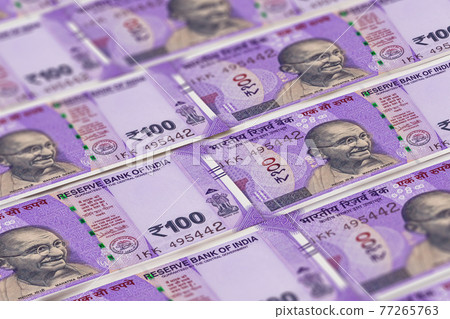 Indian rupees banknotes background. 100 INR 77265763