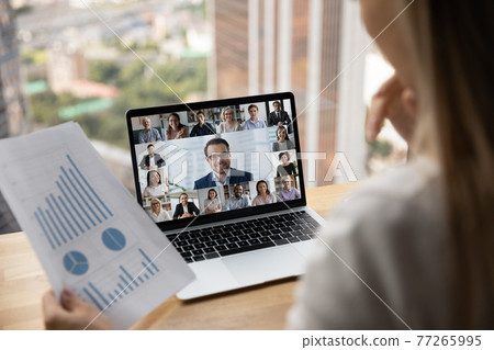 Diverse colleagues talk on video call on laptop Diverse colleagues talk on video call on laptop 77265995