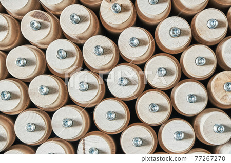 Lathe wooden legs stacked vertically in a cardboard box extreme closeup upper view Lathe wooden legs stacked vertically in a cardboard box extreme closeup upper view 77267270