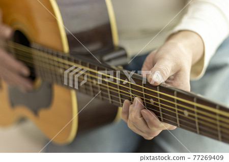 Image of a senior woman practicing guitar (60s, Japanese) Image of a senior woman practicing guitar (60s, Japanese) 77269409