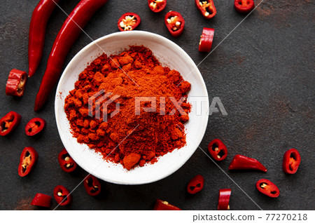 Red chili pepper, dried chillies on dark background. Top view Red chili pepper, dried chillies on dark background. Top view 77270218