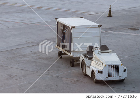 Vehicle for cargo on wait for transport to airplane at airport Vehicle for cargo on wait for transport to airplane at airport 77271630