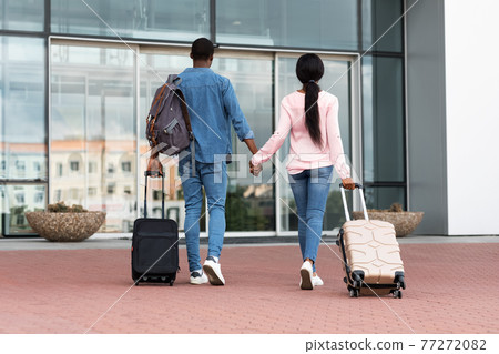Ready For Travel. Rear View Of Black Couple With Luggage Entering Airport 77272082