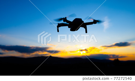Drone silhouette at sunset time Drone silhouette at sunset time 77272540