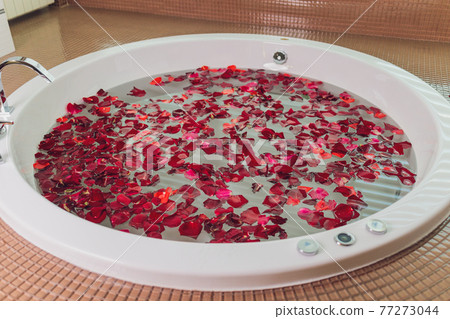 portrait of beautyfull hot pinup girl, red hair taking relaxing bath with flower petals on white copy space background , outdoor. portrait of beautyfull hot pinup girl, red hair taking relaxing bath with flower petals on white copy space background , outdoor. 77273044
