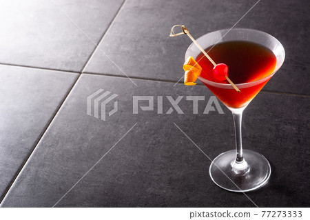 Traditional Manhattan cocktail with cherry Traditional Manhattan cocktail with cherry 77273333