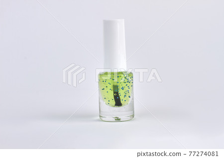 Green transparent nail polish isolated on white background. 77274081