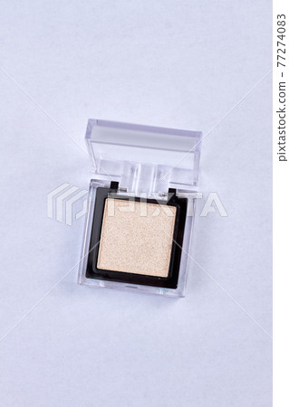 Box with golden eyeshadowes isolated on white background. Box with golden eyeshadowes isolated on white background. 77274083