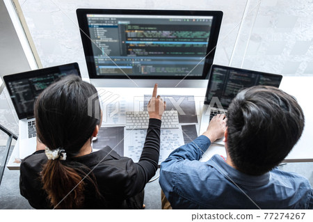 Professional Team of programmer working on project in software development computer in IT company office, Writing codes and data code website and coding database technologies on new Application 77274267