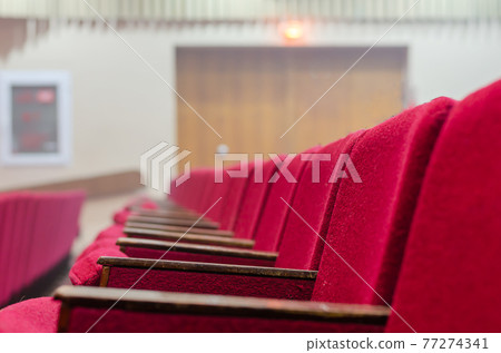 Red chairs of the concert hall. Red chairs of the concert hall. 77274341