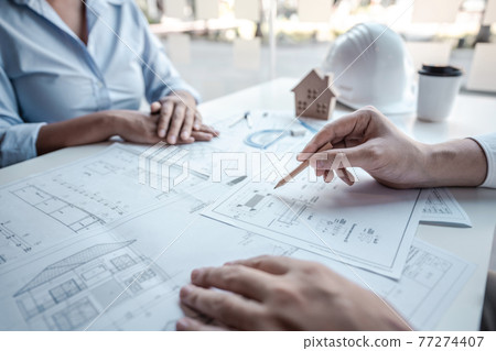 Architects or engineering team consulting and analyzing working on objects tools and construction drawings inspection planning new architectural project on blueprint and model house in modern office Architects or engineering team consulting and analyzing working on objects tools and construction drawings inspection planning new architectural project on blueprint and model house in modern office 77274407