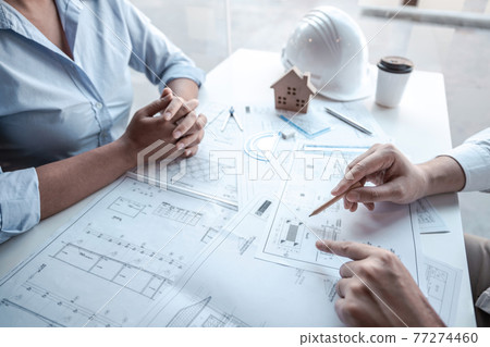 Architects or engineering team consulting and analyzing working on objects tools and construction drawings inspection planning new architectural project on blueprint and model house in modern office Architects or engineering team consulting and analyzing working on objects tools and construction drawings inspection planning new architectural project on blueprint and model house in modern office 77274460