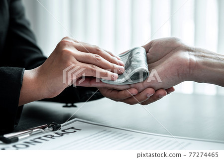 Business woman giving bribe money to businessman to bribing deal contract in a corruption, Illegal, dishonest and scam Business woman giving bribe money to businessman to bribing deal contract in a corruption, Illegal, dishonest and scam 77274465