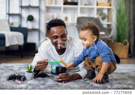 Young father and son drawing with pencils at home Young father and son drawing with pencils at home 77275608