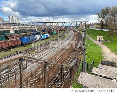 Railway wagons with cargo of metal and grain in port of Odessa. trains are waiting in line for loading at cargo terminal. most economical logistics solutions for rail transport Railway wagons with cargo of metal and grain in port of Odessa. trains are waiting in line for loading at cargo terminal. most economical logistics solutions for rail transport 77277117