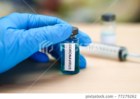 Novel Coronavirus (2019-nCoV) vaccine development medical with syringe for doctor use to treat pneumonia illness patients at Wuhan, China. 77279262