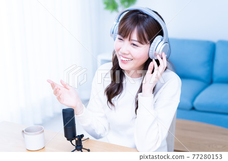 Young woman singing in the living room 77280153