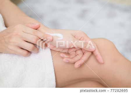 Woman applying natural cream, Woman moisturizing her hand with cosmetic cream, Spa and Manicure concept. Woman applying natural cream, Woman moisturizing her hand with cosmetic cream, Spa and Manicure concept. 77282695