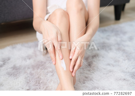 Woman applying natural cream, Woman moisturizing her leg with cosmetic cream with copy space. Woman applying natural cream, Woman moisturizing her leg with cosmetic cream with copy space. 77282697