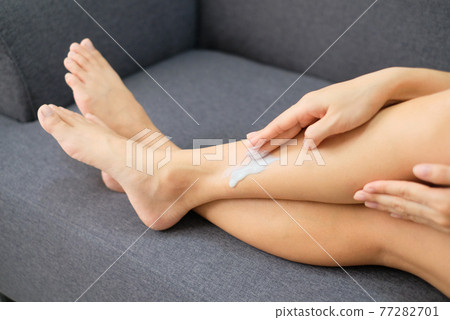 Woman applying natural cream, Woman moisturizing her leg with cosmetic cream with copy space. Woman applying natural cream, Woman moisturizing her leg with cosmetic cream with copy space. 77282701