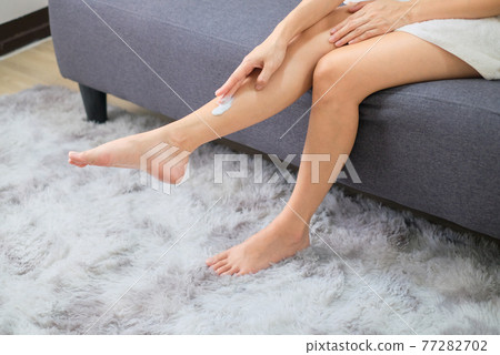 Woman applying natural cream, Woman moisturizing her leg with cosmetic cream with copy space. Woman applying natural cream, Woman moisturizing her leg with cosmetic cream with copy space. 77282702