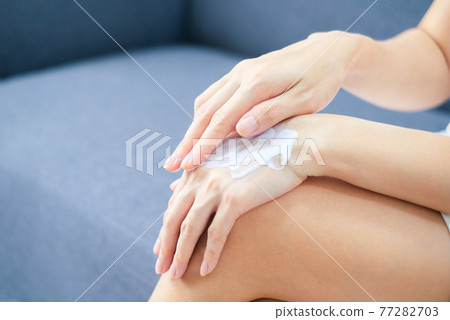 Woman applying natural cream, Woman moisturizing her hand with cosmetic cream, Spa and Manicure concept. Woman applying natural cream, Woman moisturizing her hand with cosmetic cream, Spa and Manicure concept. 77282703