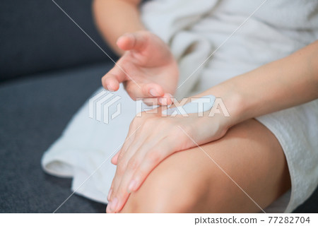 Woman applying natural cream, Woman moisturizing her hand with cosmetic cream, Spa and Manicure concept. 77282704