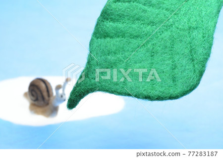 Snails and green leaves made from needle felt Snails and green leaves made from needle felt 77283187