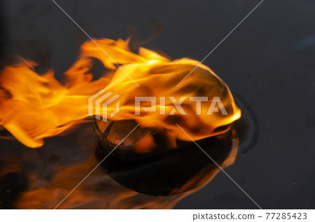 Close-up of a laptop or computer control device on fire. Close-up of a laptop or computer control device on fire. 77285423