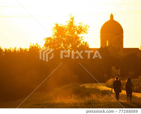Sunset in summer with silhouette of church dome, Italy Sunset in summer with silhouette of church dome, Italy 77288089