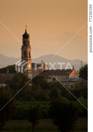 Sunset in summer with silhouette of church tower, Italy Sunset in summer with silhouette of church tower, Italy 77288160