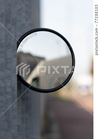 View of a circular mirror on a metal fence, Reggio Emilia. Italy 77288183