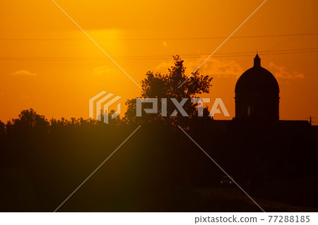 Sunset in summer with silhouette of church dome, Italy Sunset in summer with silhouette of church dome, Italy 77288185