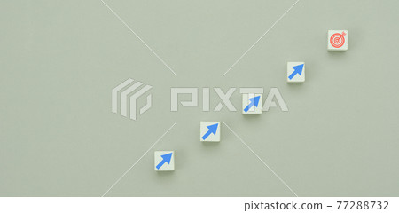 Top view arrow go up on wood block stacking same as step stair to dart board on grey paper background, Business growth up concept. Success stock market . management achievement goal. Strategy target. 77288732