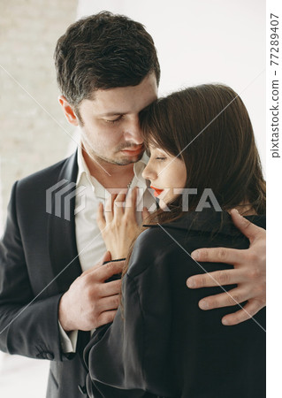 Portrait of young couple in love posing at studio 77289407