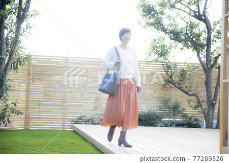 Female 50s outdoors 77289826