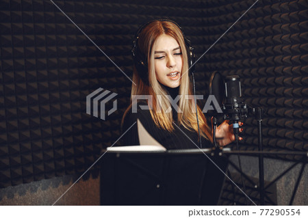 Singing and working in a studio with a microphone 77290554