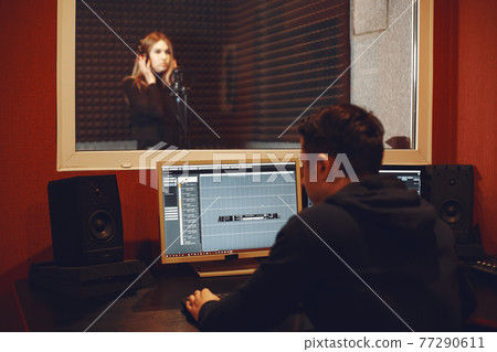 Singing and working in a studio with a microphone Singing and working in a studio with a microphone 77290611