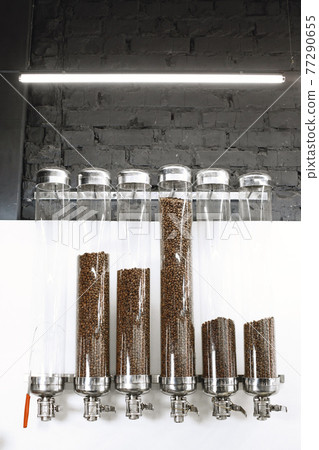 Coffee is poured into beans in glass containers Coffee is poured into beans in glass containers 77290655
