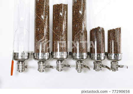 Coffee is poured into beans in glass containers Coffee is poured into beans in glass containers 77290656