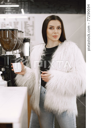 Girl chooses a drink at counter 77290694